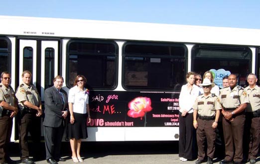 Representatives of Constable Bruce Elfant's office and Impact 3 staff with the 2008 bus ad campaign